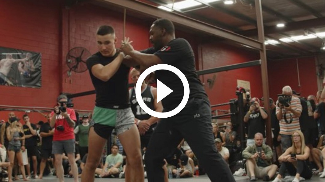 Jon Jones teaches his iconic elbow push at a gym in Australia